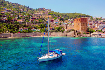White yacht in the sea bay. Harbor of the Red Tower Alanya, Turkey. - obrazy, fototapety, plakaty