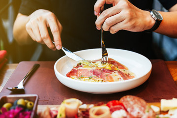 Hand rotate the shaft of the fork, twining the strands of pasta around the tines for eating...