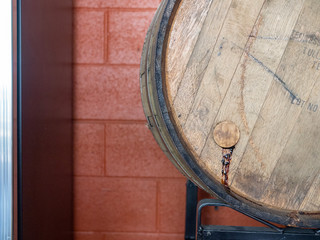 Leaking barrel filled with beer or wine resting in warehouse