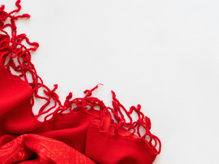 Bright red scarf on white background. Folded warm accessory with copy space.