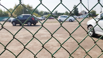 Cars behind a mesh fence. Security, guarded parking, fine, arrest concept © Yevhen Roshchyn