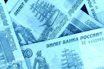 Banknote background from Russian rubles close up. Blue color toned