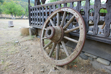 Fototapeta premium old (vintage) wooden wheel. 19th century wagon wooden wheel. antique metal parts made in the forge
