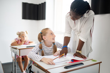 Girl feeling thankful to teacher clarifying some details