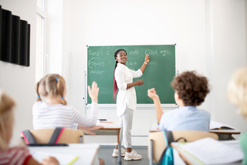 Active children raising hands while knowing the answer