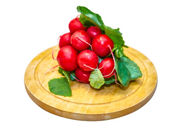 Fresh radishes with leaves lying on the Board