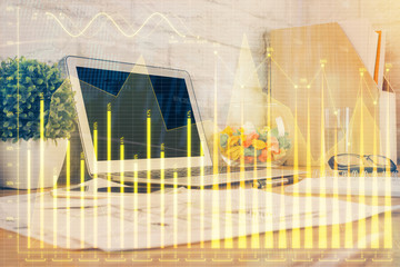 Financial graph colorful drawing and table with computer on background. Double exposure. Concept of international markets.