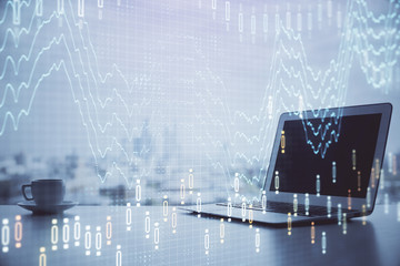 Forex graph hologram on table with computer background. Multi exposure. Concept of financial markets.