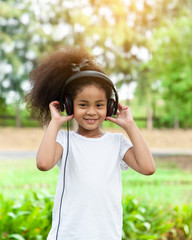 Portrait of cute girl playing and listen music in the park, enjoying life.