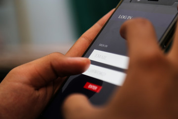 attractive hands writing sign username on a smart phone