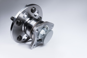 New Wheel hub assembly with bearing. This is part of the car suspension on a gray background with a gradient. The concept of new car parts