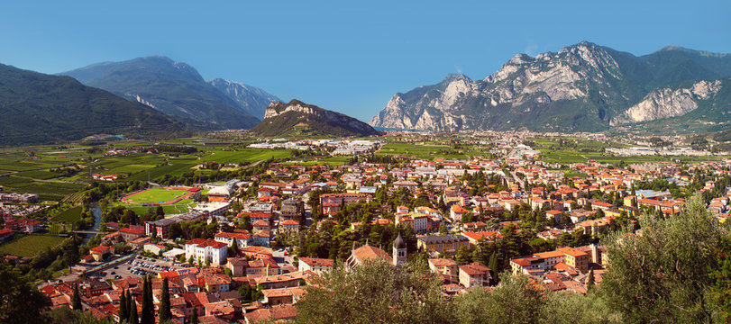 Landscape - valley with village among mountains, high mountain Monte Brione and lake Garda (Lago di Garda) in the background, view from Arco Castle (Castello di Arco), Italy