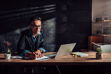 Businessman writing notes and contemplating in his office