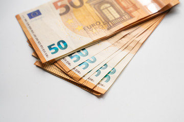Euro money pile spread on white background