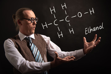 Professor presenting handdrawn chemical formula of ethanol