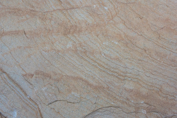 Weathered rock and sandstone wavy stripes closeup background