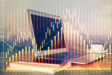 Financial chart drawing and table with computer on background. Double exposure. Concept of international markets.