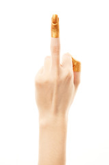 Hands in gold paint. Golden fingers. Middle finger. Woman showing her aggressiveness and discontent. Woman hand showing middle finger on a white isolated background.