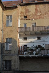 Fototapeta na wymiar Old tall brick house with balcony 01