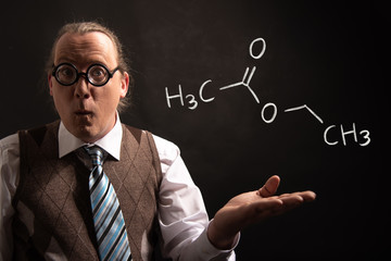 Professor presenting handdrawn chemical formula of ethyl acetate