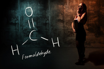 Sexy girl or secretary or female student presenting handdrawn chemical formula of Formaldehyde