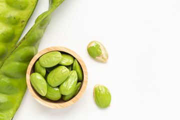 Sato seeds, Bitter bean in the Wooden bowl isolated on white background, Thai vegetable food