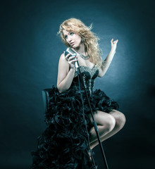 beautiful female singer in black concert dress performing jazz