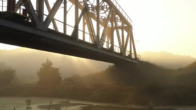 4k Iron railway bridge at dawn in the fog