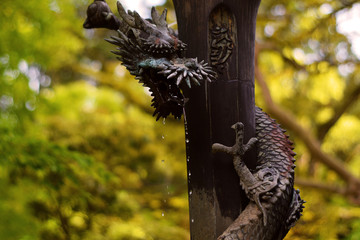 Brunnen mit wasserspeienden Drachen Skulptur im Herbst