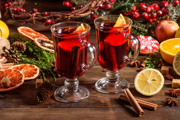 Christmas hot mulled wine with cinnamon cardamom and anise on wooden background