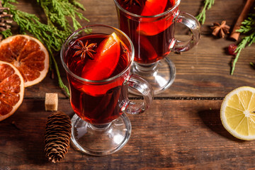 Christmas hot mulled wine with cinnamon cardamom and anise on wooden background