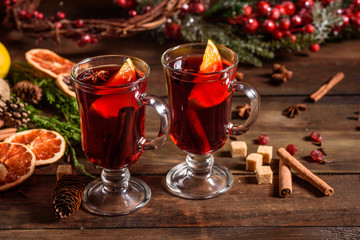 Christmas hot mulled wine with cinnamon cardamom and anise on wooden background