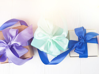 blue boxes with purple bows, Christmas presents on white background, copy space