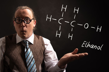 Professor presenting handdrawn chemical formula of ethanol