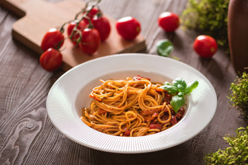 Spaghetti with tomato sauce on rustic background