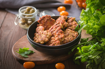 Homemade chicken cutlets on rustic background