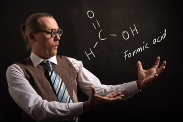 Professor presenting handdrawn chemical formula of formic acid