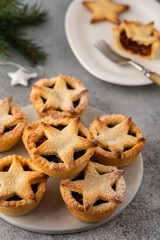 Delicious fruit mince tarts for Christmas dinner. Grey background, selective focus
