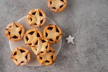 Delicious fruit mince tarts for Christmas dinner. Grey background, selective focus