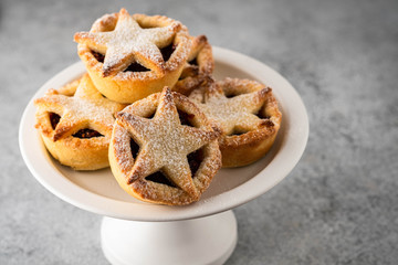 Delicious fruit mince tarts for Christmas dinner. Grey background, selective focus