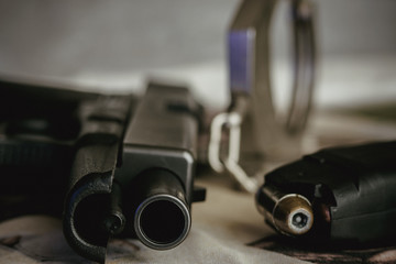 Obraz premium Police and security pistol magazine and handcuffs