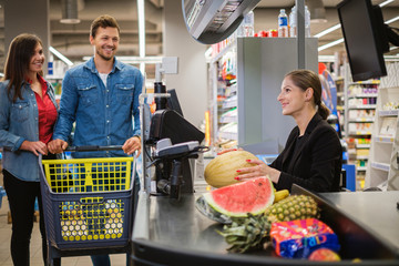 Young couple buying goods in a grocery store