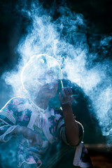 Senior Lahu woman smoking cigarette in sunrise.