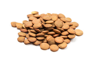 Isolated stack of uncooked lentils on white background from above.
