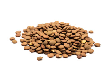 Isolated stack of uncooked lentils on white background from above.