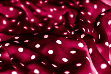 Classic polka dot textile background texture, white dots on red luxury fabric design pattern © Anneleven
