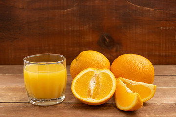 Oranges lie on a wooden table.