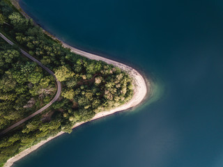 Blue lake and green forest during sunset