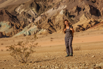 A hiker in the Artist`s Palette landmark place in Death Valley National Park, Geology, sand.