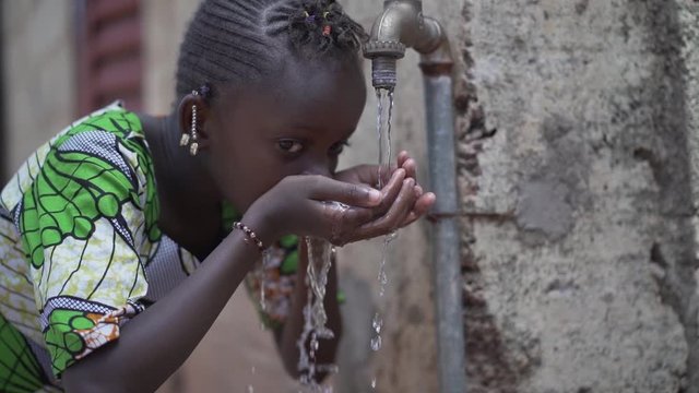 Candid Video of African Schoolgirl drinking Safe water from tap outdoors in Bamako, Mali